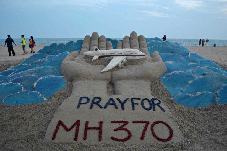 a sand sculpture made by indian sand artist sudersan pattnaik with a message of prayers for the missing malaysian airlines flight mh370 photo afp