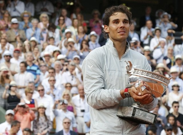 rafael nadal of spain holds the trophy during the ceremony after defeating novak djokovic of serbia during their men 039 s singles final match to win the french open tennis tournament at the roland garros stadium in paris june 8 2014 photo reuters