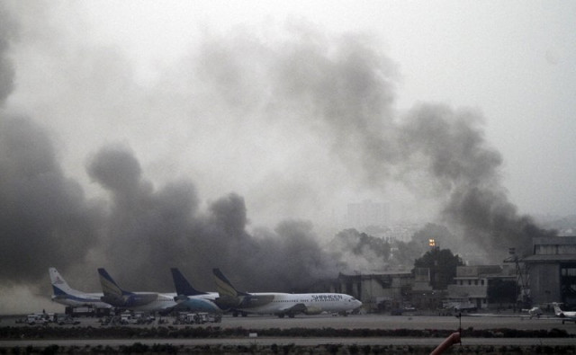 smoke rises from the cargo storage unit at the old terminal of the karachi airport on monday morning several people were stuck inside its close storage facility on monday evening photo reuters