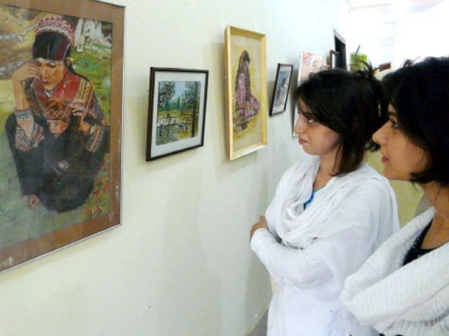 visitors take in one of the pieces on display at the exhibition photo inp visitors take in one of the pieces on display at the exhibition photo inp