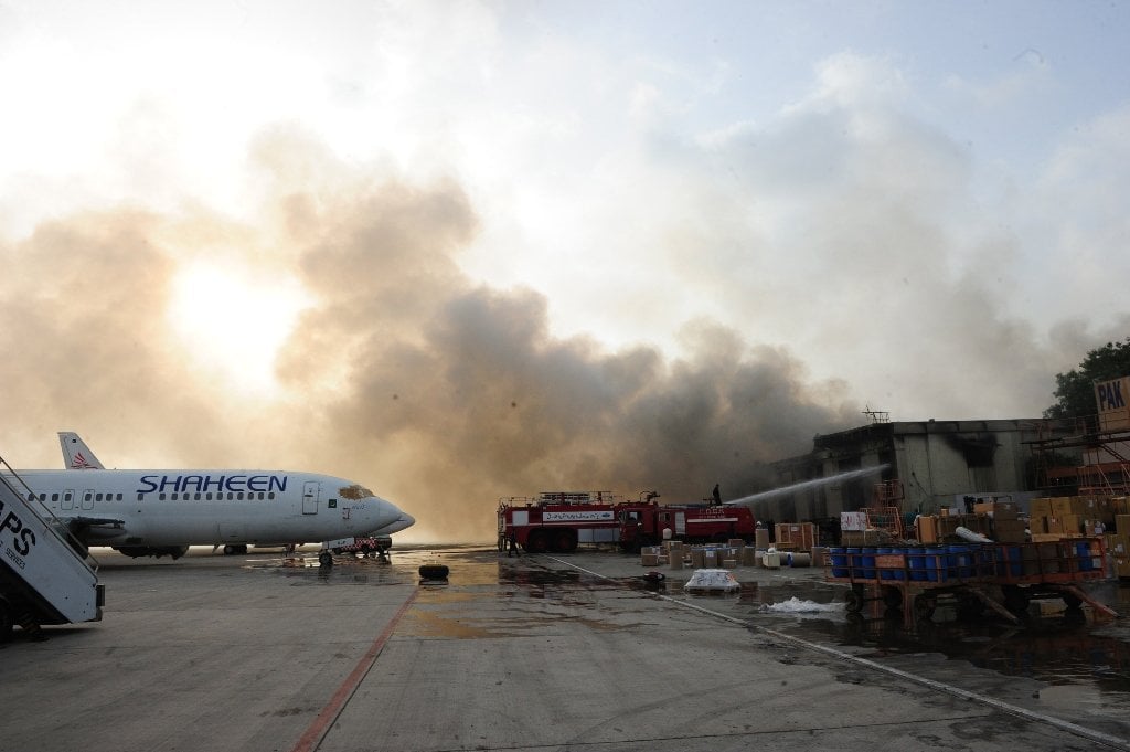 smoke rises after militants launched an assault at jinnah international airport in karachi photo afp