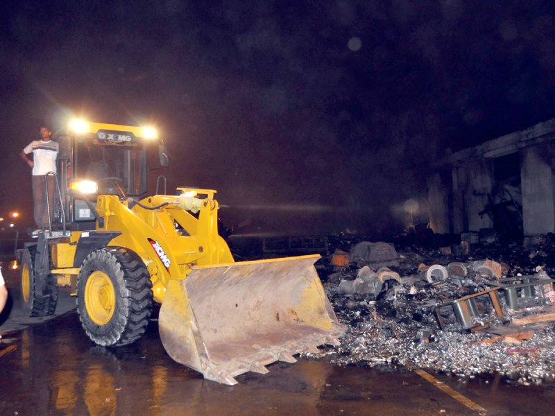 a bulldozer clears debris at karachi airport photo mohammad noman express