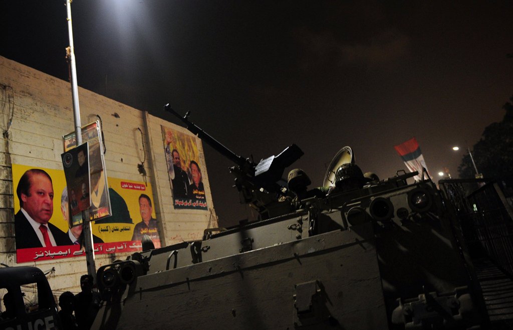 troops take position with an armored vehicle at the karachi airport terminal after the militants 039 assault in karachi on june 8 2014 photo afp