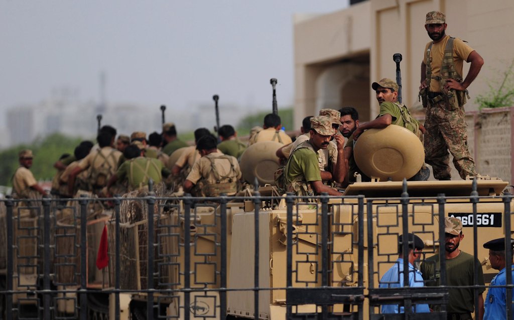 army personnel stand guard in armoured vehicles after a search operation following an assault by militants at karachi airport terminal in karachi on june 9 2014 photo afp