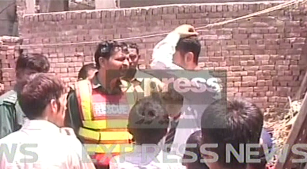 express news screengrab of a rescue official near the collapsed house