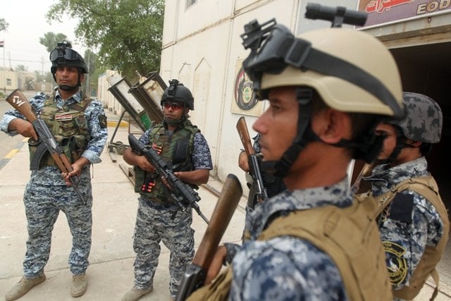 iraqi policemen listen to a talk inside a military base in baghdad after jihadists seized the city of mosul and nineveh photo afp