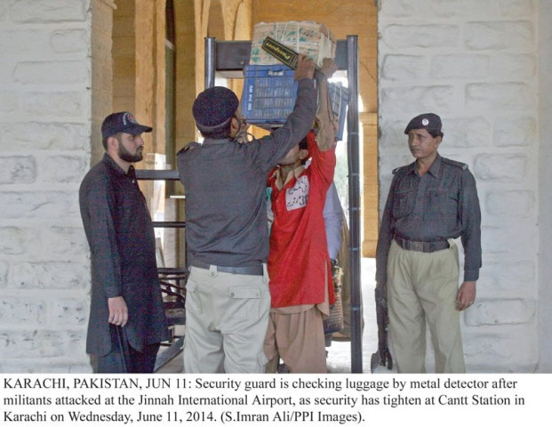 a police official scans luggage with a portable metal detector at the karachi cantt station on wednesday security has been beefed up at all sensitive sites across the city photo ppi a police official scans luggage with a portable metal detector at the karachi cantt station on wednesday security has been beefed up at all sensitive sites across the city photo ppi