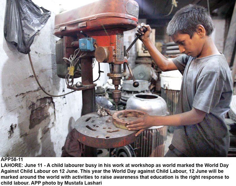 a child labourer operates a drill machine at a workshop in lahore photo app