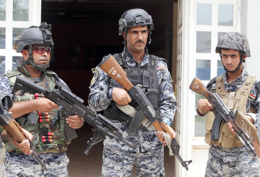 iraqi policemen listen to a briefing inside a military base in the capital baghdad on june 11 2014 photo afp