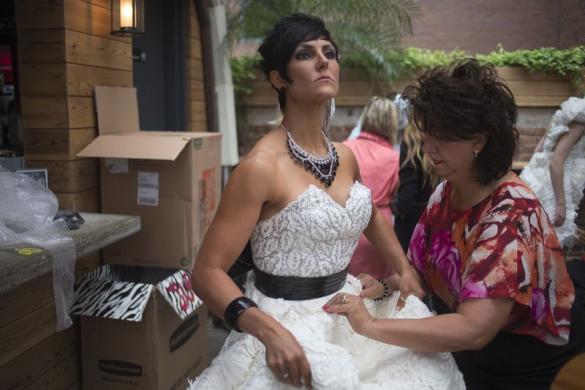 designer julie hass r of stockton illinois puts the final touches on her creation worn by jewel howard of iowa named 039 jubilee 039 during the 10th annual toilet paper wedding dress contest in midtown new york june 12 2014 photo reuters