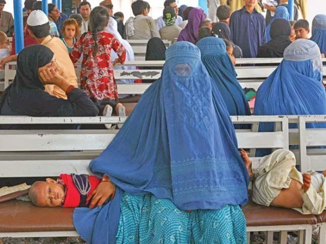 an afghan refugee woman waits with her children to register at the unhcr office photo file an afghan refugee woman waits with her children to register at the unhcr office photo file