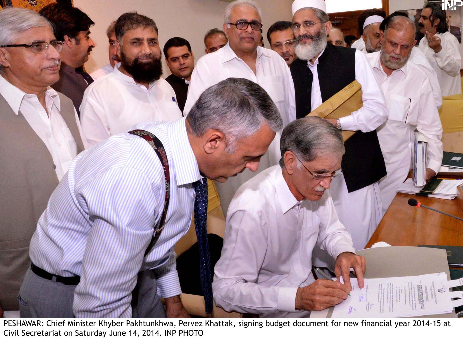 khyber pakhtunkhwa chief minister pervez khattak signs the budget document for fiscal year 2014 15 at the civil secretariat on saturday photo inp