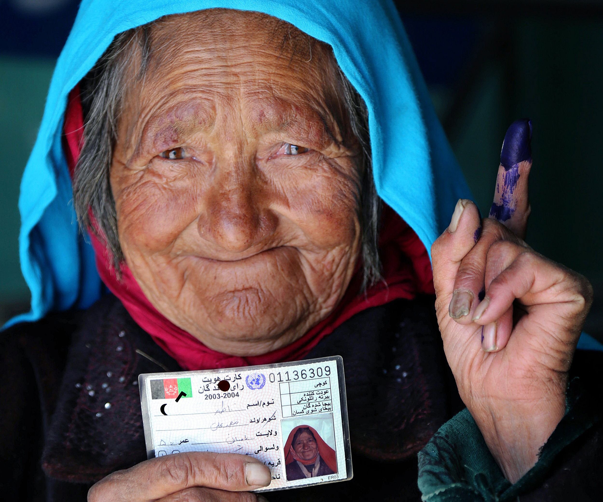 afghan woman showing phosphorous ink on her finger after casting vote for her favourite candidate photo afp