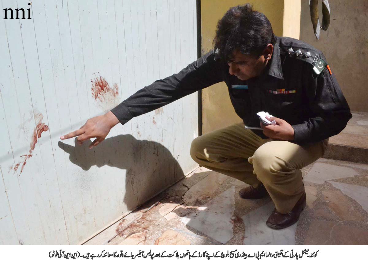 a police official points to spots of bloods on the wall after the murder of mpa handery masieh in quetta on saturday photo nni