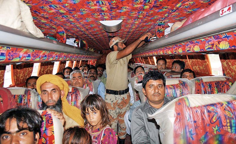 a rangers official checks the identification documents and luggage of the occupants of a passenger bus at the super highway on monday rangers personnel conduct these security checks at all entry and exit points of the city to curb the influx of militants and illegal immigrants into the city photo online