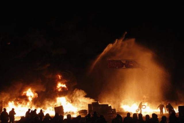 in this file photo a pro european protester throws tyres into a fire during street violence in kiev photo reuters in this file photo a pro european protester throws tyres into a fire during street violence in kiev photo reuters