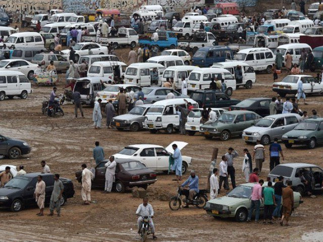 n this photograph taken on july 26 2015 people gather around cars at the sunday car market in karachi photo afp n this photograph taken on july 26 2015 people gather around cars at the sunday car market in karachi photo afp