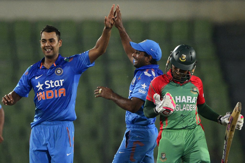 indian cricketer stuart binny l celebrates with his teammate after the dismissal of bangladeshi cricket captain mushfiqur rahim r during the second one day international odi cricket match between india and bangladesh at the sher e bangla national cricket stadium in dhaka on june 17 2014 photo afp