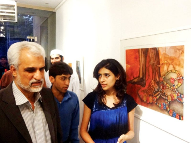 art enthusiasts look at the paintings at the exhibition photo abid nawaz express art enthusiasts look at the paintings at the exhibition photo abid nawaz express