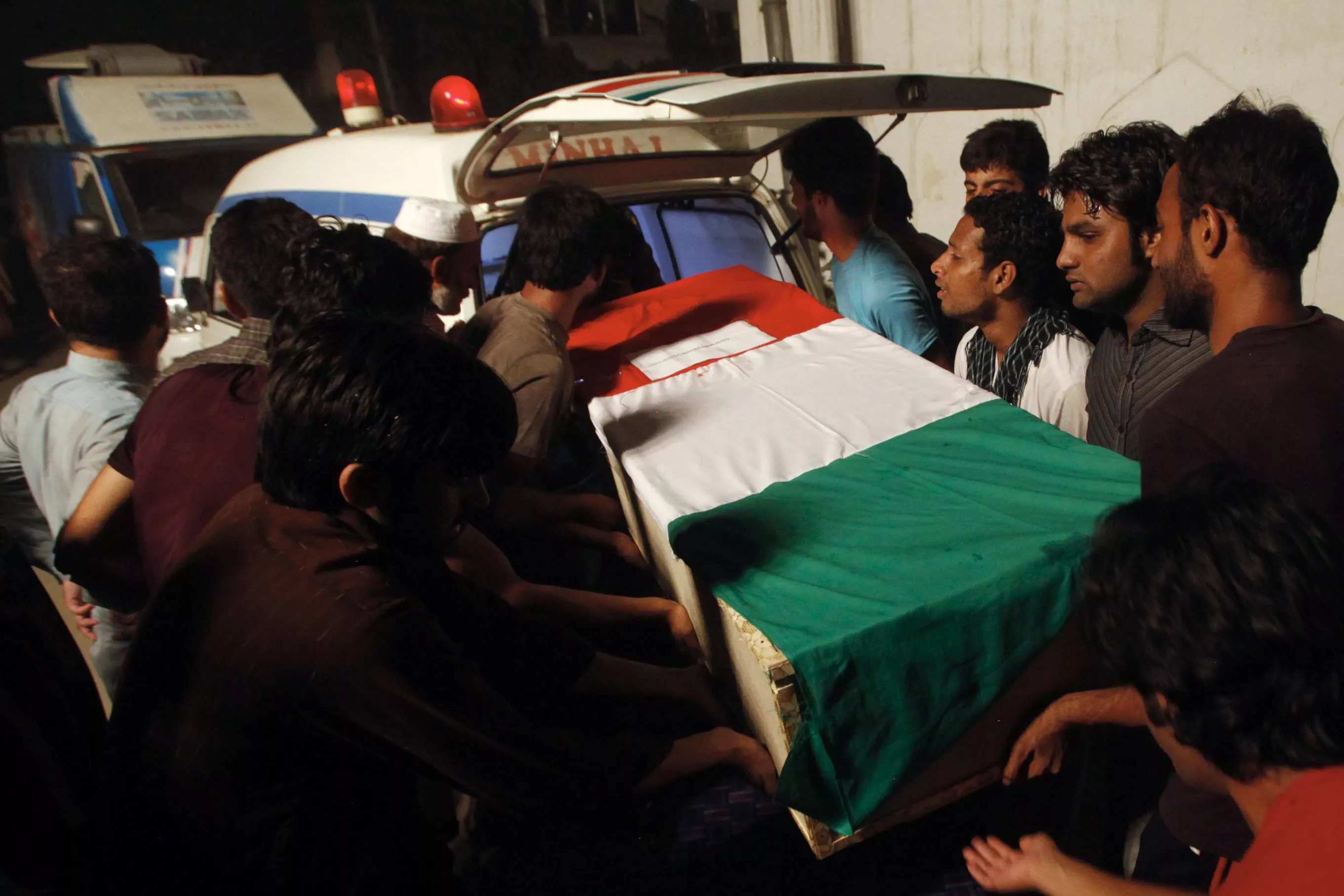 a coffin bearing a slain supporter of tahirul qadri killed during clashes with police is shifted into an ambulance during a funeral ceremony in lahore photo afp a coffin bearing a slain supporter of tahirul qadri killed during clashes with police is shifted into an ambulance during a funeral ceremony in lahore photo afp