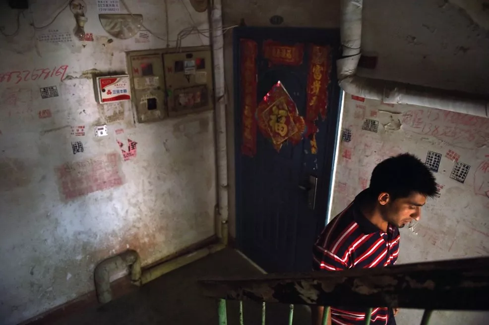 this photo taken on june 18 2014 shows a pakistani refugee as he walks past chinese decorations in the stairwell of his apartment building in sanhe in china 039 s hebei province east of beijing photo afp this photo taken on june 18 2014 shows a pakistani refugee as he walks past chinese decorations in the stairwell of his apartment building in sanhe in china 039 s hebei province east of beijing photo afp