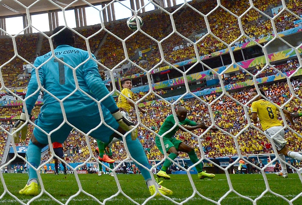 ivory coast 039 s goalkeeper boubacar barry fails to stop a goal by colombia 039 s midfielder james rodriguez c during a group c football match between colombia and ivory coast at the mane garrincha national stadium in brasilia during the 2014 fifa world cup on june 19 2014 photo afp