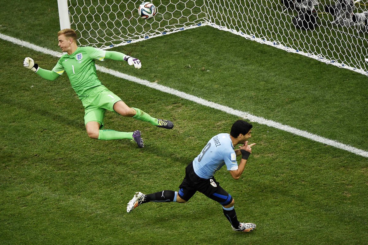 uruguay 039 s forward luis suarez r celebrates after scoring against england 039 s goalkeeper joe hart l during a group d football match between uruguay and england at the corinthians arena in sao paulo during the 2014 fifa world cup on june 19 2014 photo afp