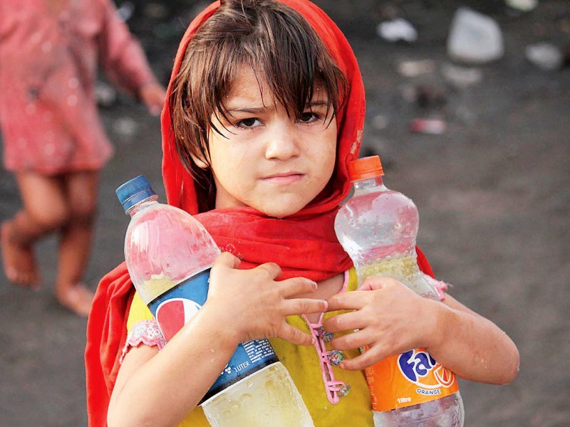 an afghan girl carries water bottles at her camp near band road photo online