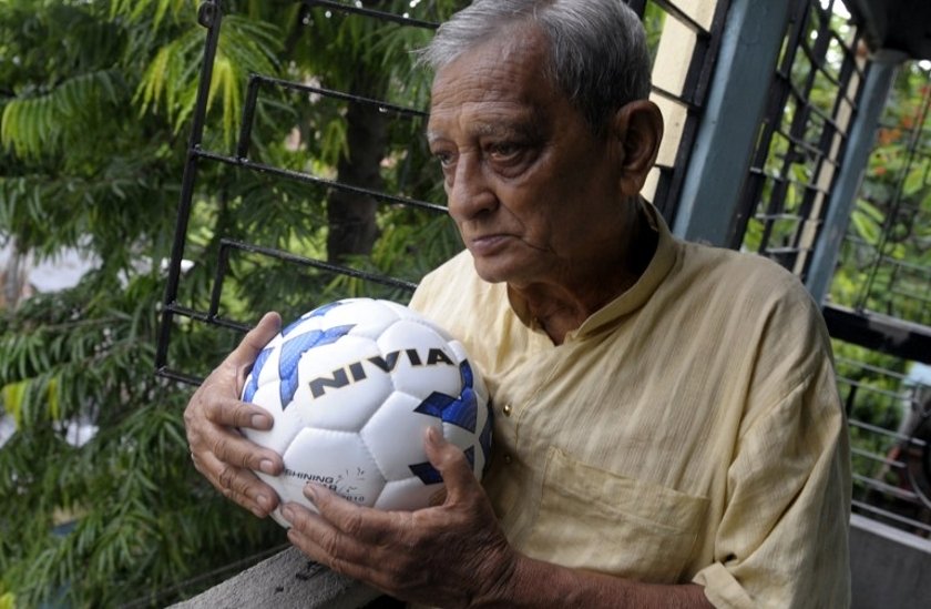 pannalal chatterjee poses on his balcony with a football before going to his regular football practice at a local ground in kolkata photo afp