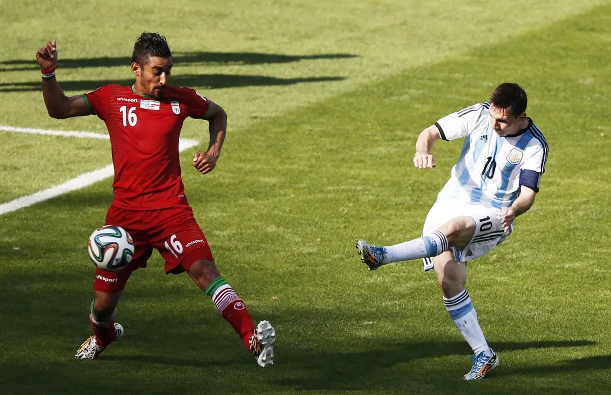 argentina 039 s lionel messi r shoots past iran 039 s forward reza ghoochannejhad to score during the group f football match between argentina and iran at the mineirao stadium in belo horizonte during the 2014 fifa world cup in brazil on june 21 2014 photo afp argentina 039 s lionel messi r shoots past iran 039 s forward reza ghoochannejhad to score during the group f football match between argentina and iran at the mineirao stadium in belo horizonte during the 2014 fifa world cup in brazil on june 21 2014 photo afp