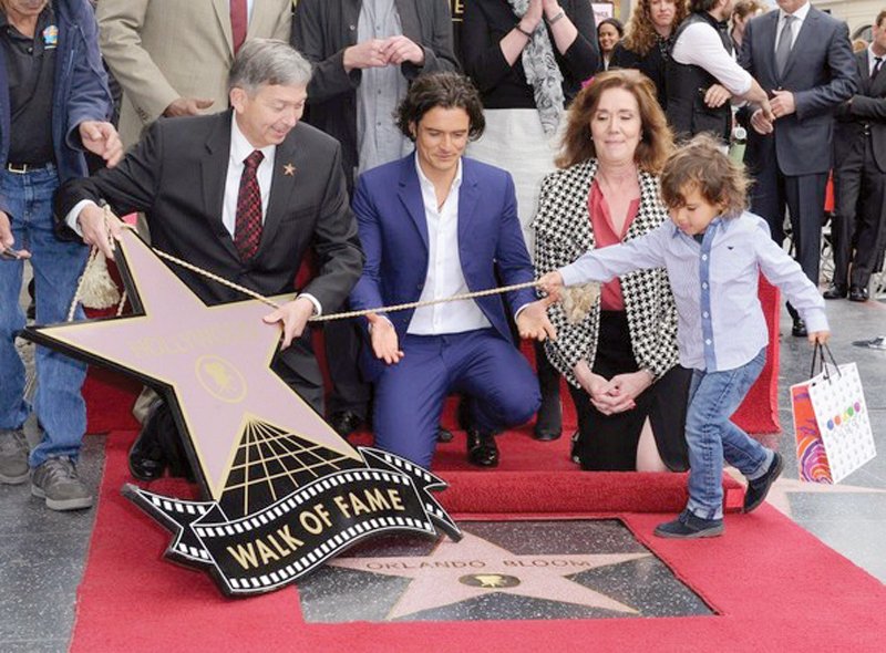 in april actor orlando bloom received his own hollywood walk of fame he came to the ceremony with his super cute son flynn photo file