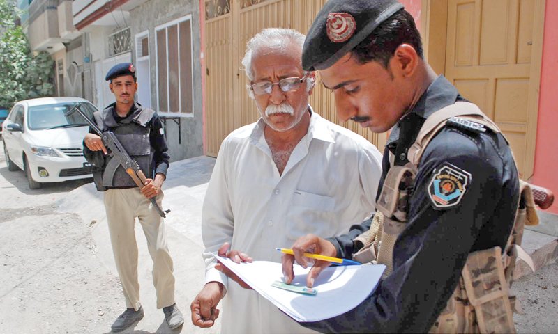 a police official questions a resident in hayatabad phase 6 during the search operation photo ppi