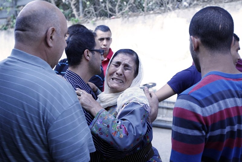 the mother of mohammed tarifi a 30 year old palestinian man who was shot dead during early morning clashes with israeli troops reacts outside a hospital on june 22 2014 in the west bank city of ramallah israeli forces shot dead two palestinians in the west bank as they continued a search for three missing israeli teens palestinian medical and security officials said photo afp