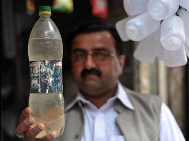 mureed abbas field officer of acid survivors foundation holds a bottle of acid for sale at a shop for 40 pakistan rupees photo afp