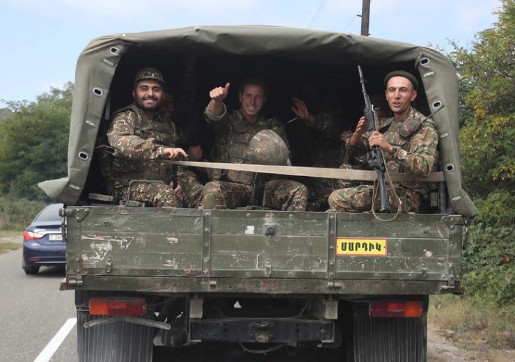 ethnic armenian soldiers react as they ride in the back of a truck in the breakaway region of nagorno karabakh september 29 photo reuters file