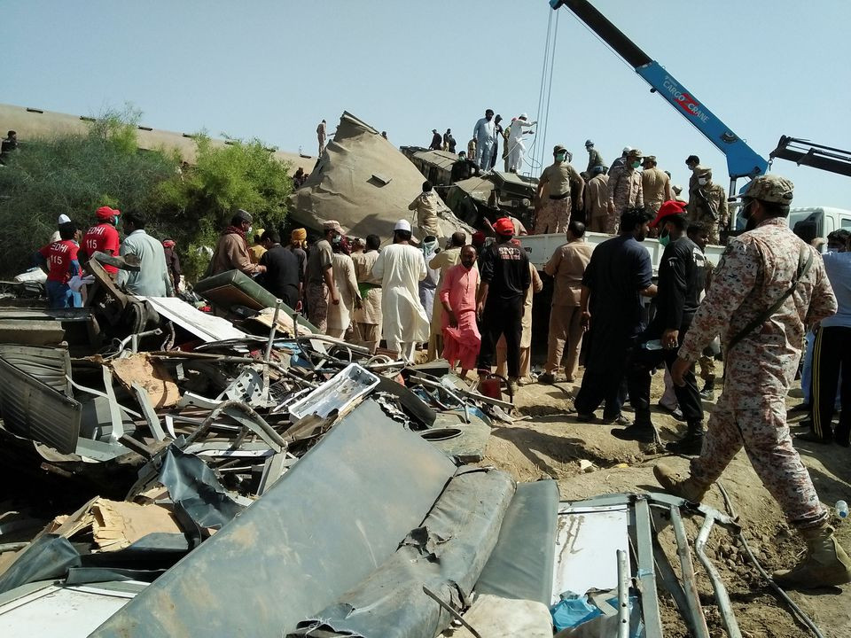 paramilitary soldiers and rescue workers gather at the site following a collision between two trains in ghotki pakistan photo reuters