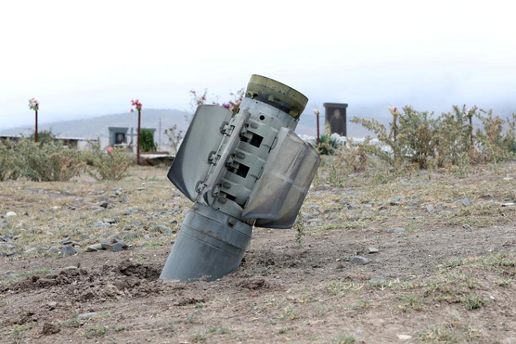 the remains of a rocket shell are seen near a graveyard at the town of ivanyan khojaly in the breakaway region of nagorno karabakh october 1 photo reuters