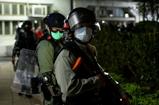 Police officers wearing face masks under their riot protection gear. PHOTO: AFP