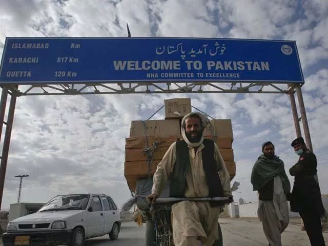 a pakhtun man passes a road sign while pulling supplies toward the pakistan afghanistan border crossing in chaman photo reuters a pakhtun man passes a road sign while pulling supplies toward the pakistan afghanistan border crossing in chaman photo reuters