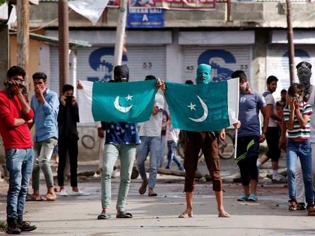 kashmiri protesters hold the flag of pakistan during a protest in srinagar against the recent killings in iok photo reuters kashmiri protesters hold the flag of pakistan during a protest in srinagar against the recent killings in iok photo reuters