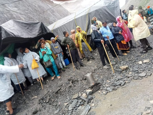 people stand outside tents after a cloudburst near the holy amarnath cave shrine in iiojk july 8 2022 photo reuters