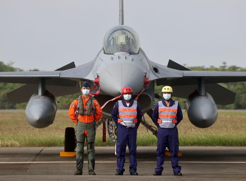 pilot and navy officers pose in front of a f 16v fighter at the commission of the first squadron of the upgraded f 16v fighters in chiayi air force base chiayi taiwan november 18 2021 photo reuters