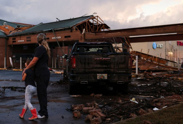 people survey the damage to a shopping center after a tornado in a widespread storm system touched down in round rock texas us march 21 2022 reuters people survey the damage to a shopping center after a tornado in a widespread storm system touched down in round rock texas us march 21 2022 reuters