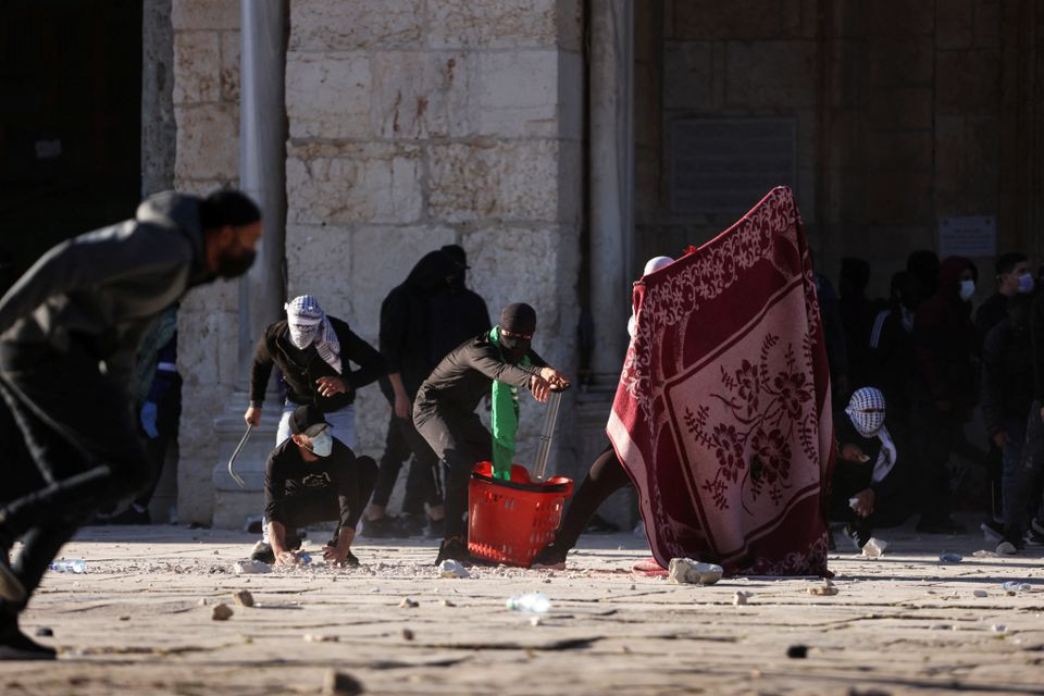 Palestinian protestors clash with Israeli security forces at the compound that houses Al-Aqsa Mosque. PHOTO: REUTERS