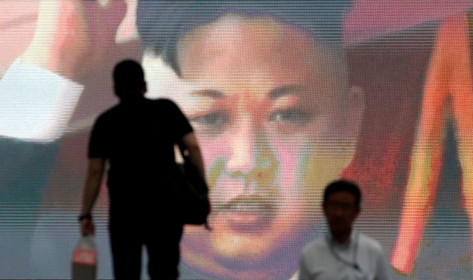 men walk past a street monitor showing news of north korea s intercontinental ballistic missile test in tokyo japan july 4 2017 photo reuters