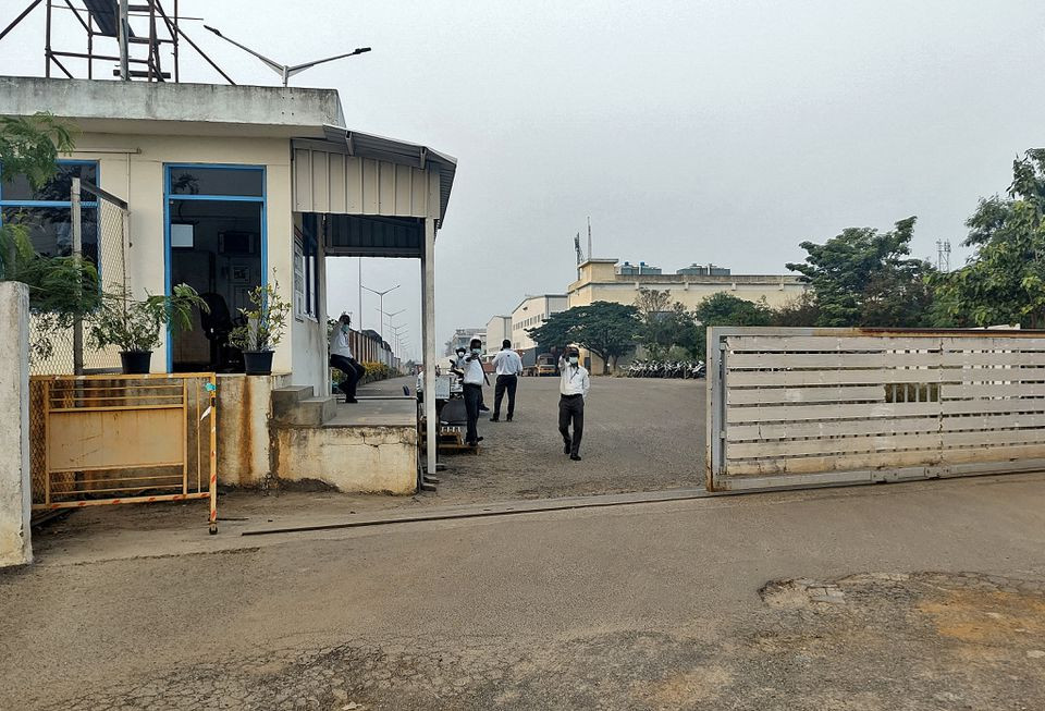 private security guards stand at the entrance of a closed plant of foxconn india which makes iphones for apple inc near chennai india december 22 2021 picture taken december 22 2021 reuters