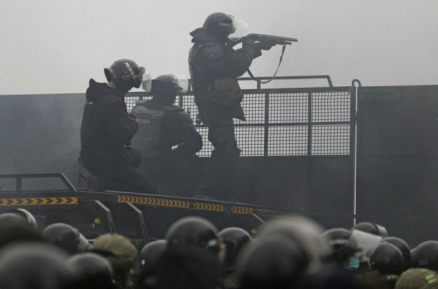 kazakh law enforcement officers are seen on a barricade during a protest triggered by fuel price increase in almaty kazakhstan january 5 2022 photo reuters kazakh law enforcement officers are seen on a barricade during a protest triggered by fuel price increase in almaty kazakhstan january 5 2022 photo reuters