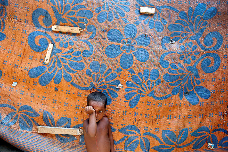 a boy from the rohingya community stands outside a shack in a camp in delhi india photo reuters