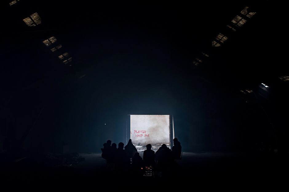 Migrants gather around a bonfire inside of derelict warehouse used as a shelter near Belgrade's main railway station with temperatures below zero Celsius. According to the latest figures, around 7000 migrants are stranded in Serbia. PHOTO: AFP