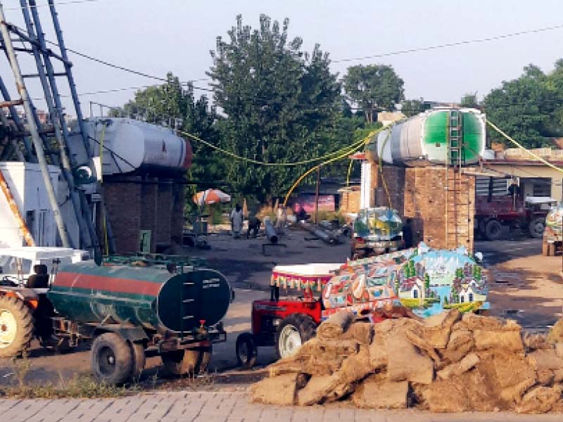 water bowsers get filled at an illegal hydrant near the soan river photo express